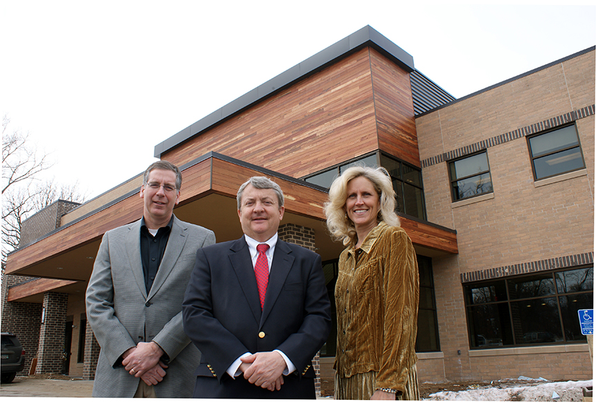 The Davis Group has a healthy pipeline of projects lined up in the Twin Cities of Minnesota and beyond. Shown in front of one of its recent developments are (from left to right) principals Michael Sharpe, Mark Davis and Jill Rasmussen. Photo by John B. Mugford