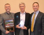 Tim Oliver (center), flanked by two of his NexCore colleagues, Todd Varney (left) and Greg Venn (right), received his HREI Insights Awards™ Lifetime Achievement Award at the RealShare HRE conference in Scottsdale, Ariz., in December. NexCore also won the award in the “Best New Development, MOBs and Other Outpatient Facilities (25,000 to 49,999 square feet)” category. (HREI photo)